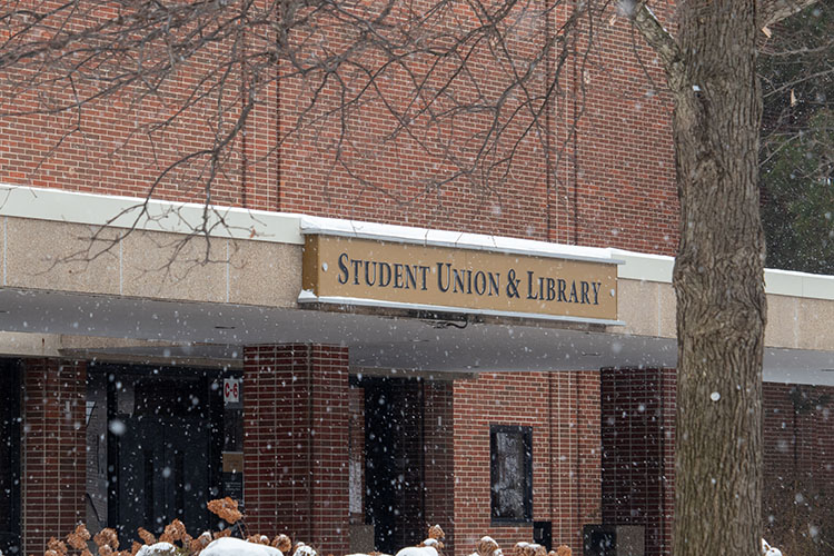 The PNW Student Union Library Building while it is snowing.