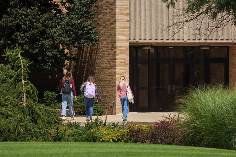 students walk into a building on the PNW Westville campus.