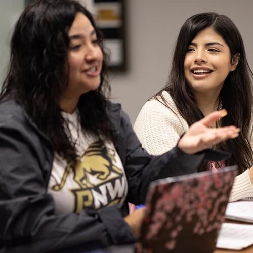 PNW students collaborate over a laptop