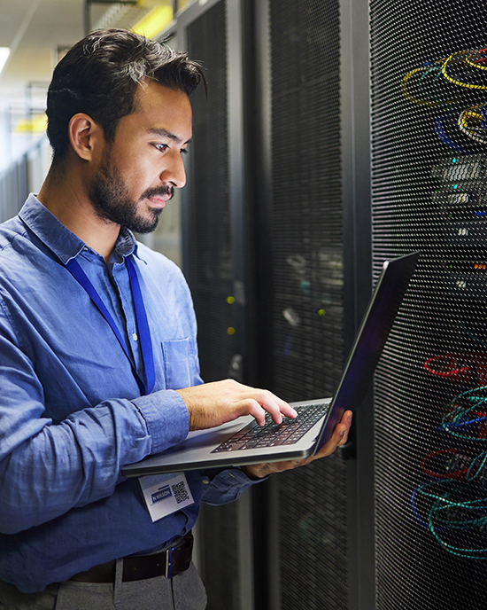 IT person on computer for tech upgrade.