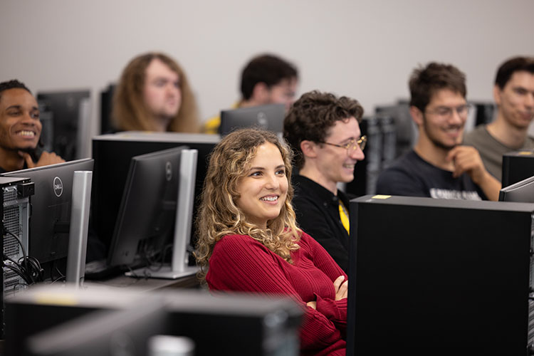 Students sit in a computer lab during class.