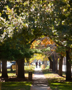 Students walk down a leafy pathway at PNW's Hammond campus