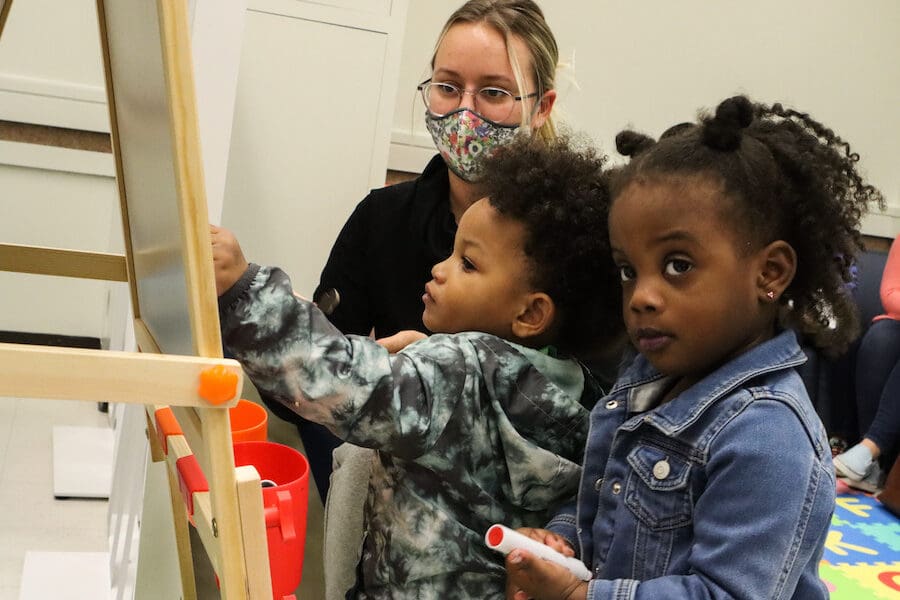 From left, PNW student Kayla Duesing plays with Isaiah Woodson and Milani Canty during an open house at the student-family lounge in the Classroom Office Building on the Hammond campus. Duesing was one of several Human Development and Family Studies students who came to observe and interact during the open house.