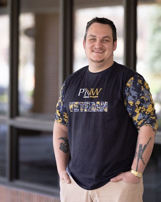 A PNW staff member in a veterans services shirt.