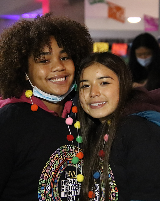 Two students smile and pose during the Hispanic Heritage Festival