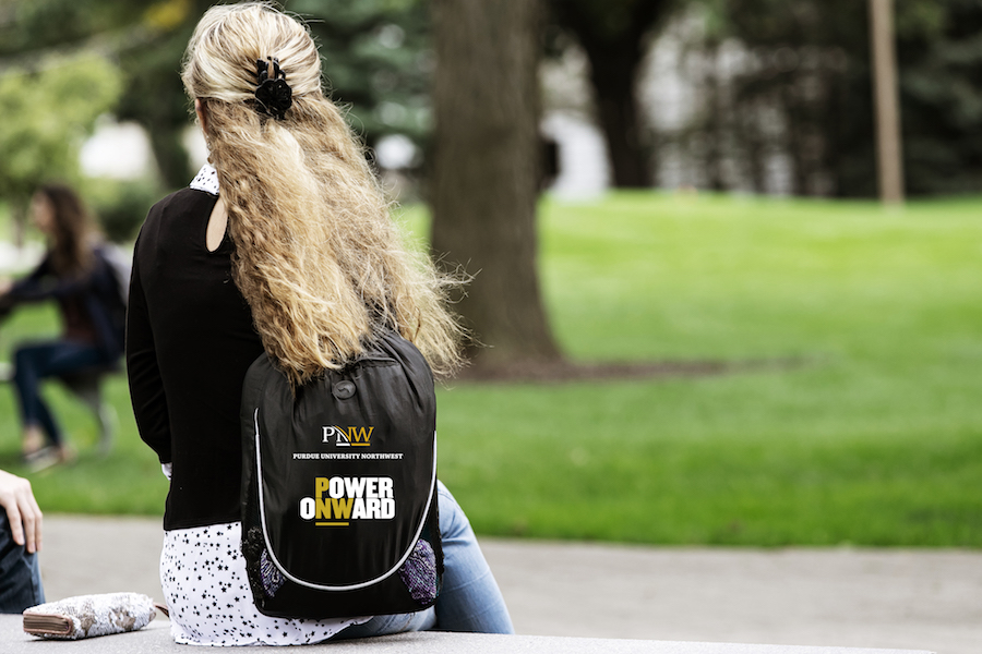 Student pictured with Power Onward backpack.