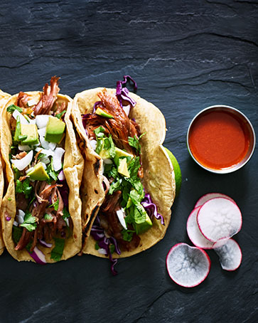 three mexican pork carnitas tacos flat lay composition