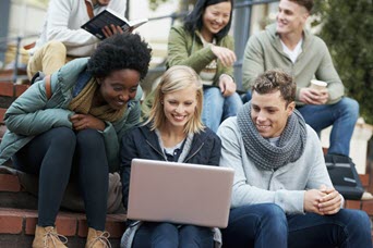 Students around a laptop computer