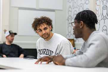 PNW students talk in a conference room