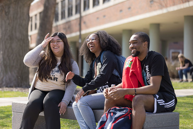 PNW students sit outdoors