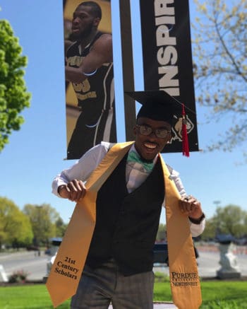 21st Century Scholar graduate posing with the sash