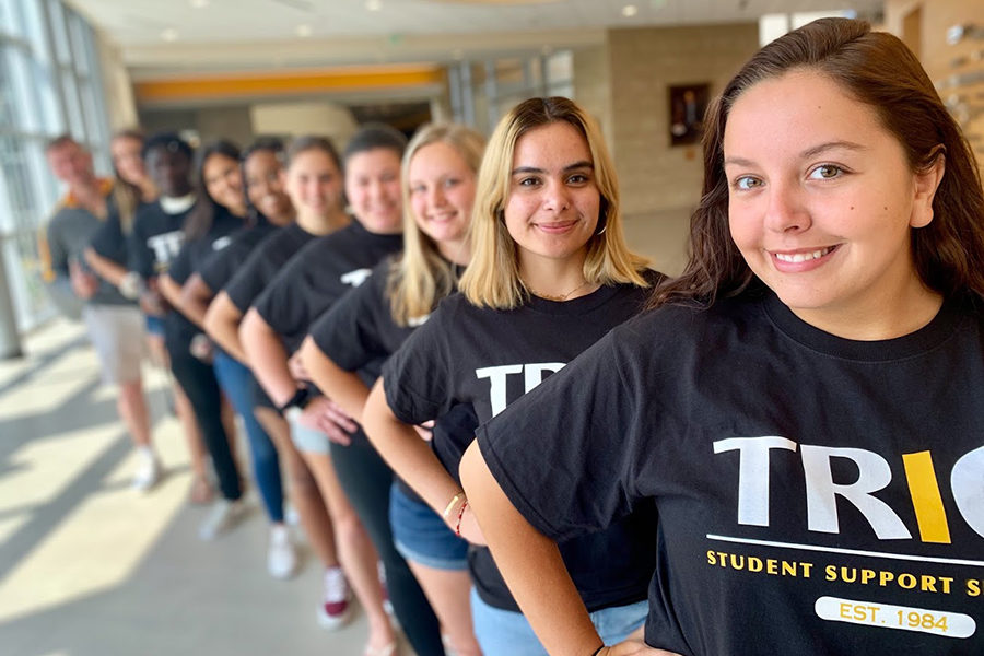 TRIO SSS students lined up in matching t-shirts with hands on hips