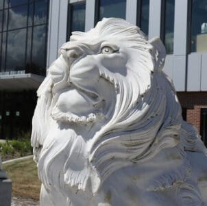 A lion sculpture in front of the Nils K Nelson Bioscience Innovation Building