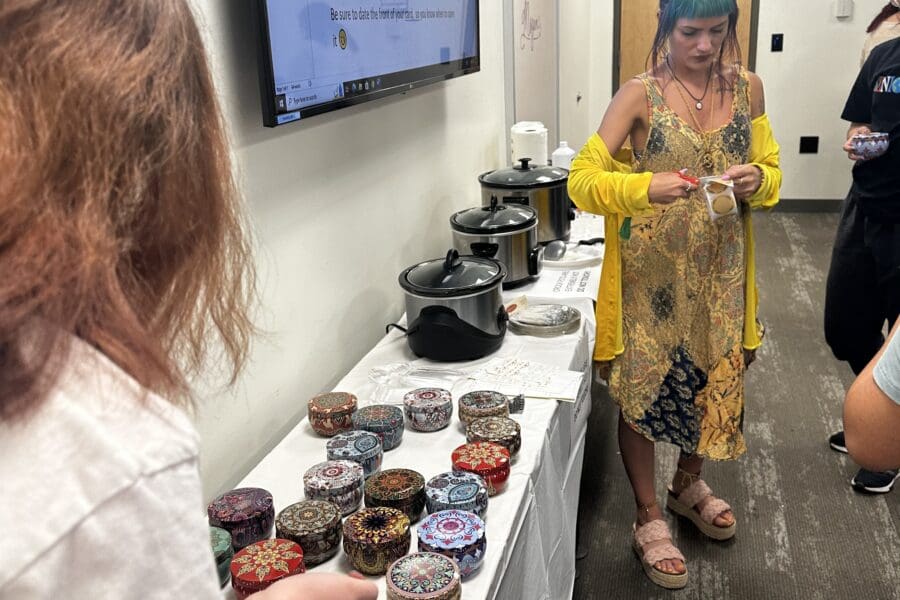 Woman teaching students how to make candles