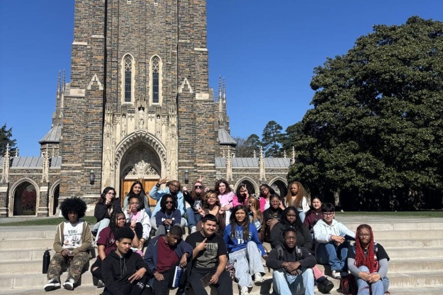 a large group of students in front of a cathedral at Duke University