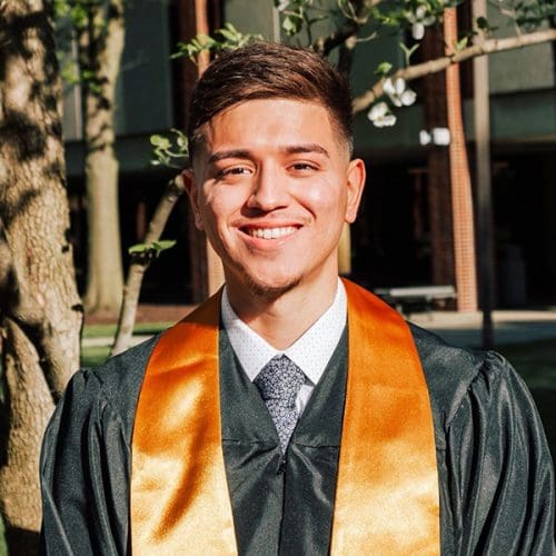 Spring 2021 Graduate Adrian Nevarez in his commencement regalia