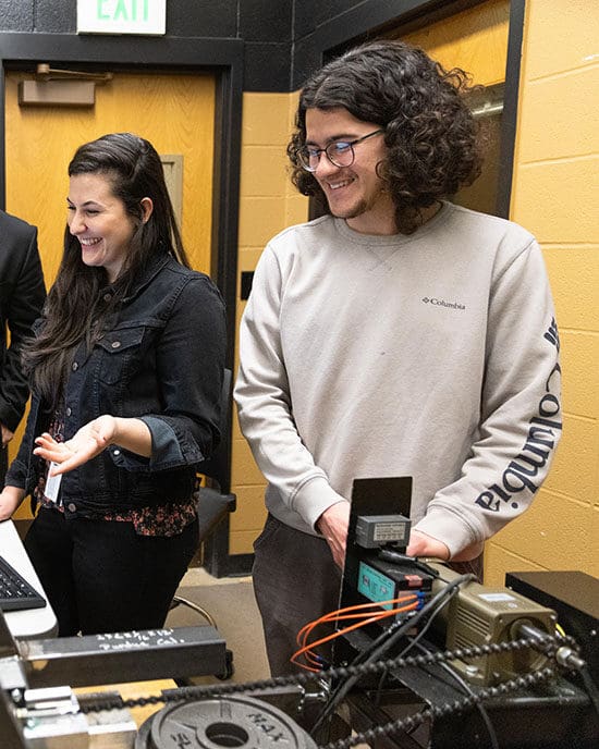 Two students work with engineering technology