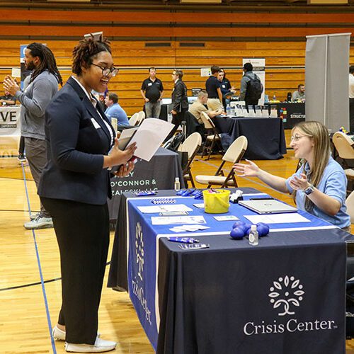 A student talks to an employer during a career fair.
