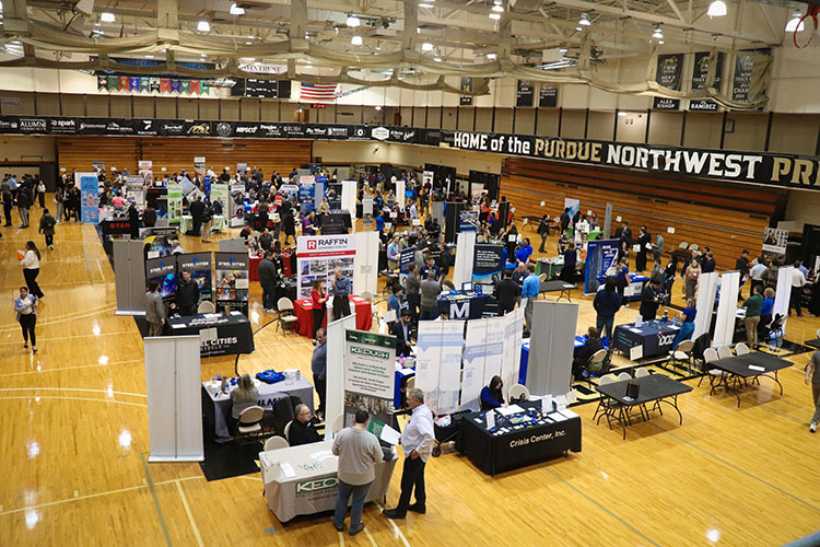 The PNW Spring Career Expo is a career fair for students and alumni of Purdue University Northwest who are seeking full-time employment and internships across all industries and academic majors. An overhead view of a PNW career fair.