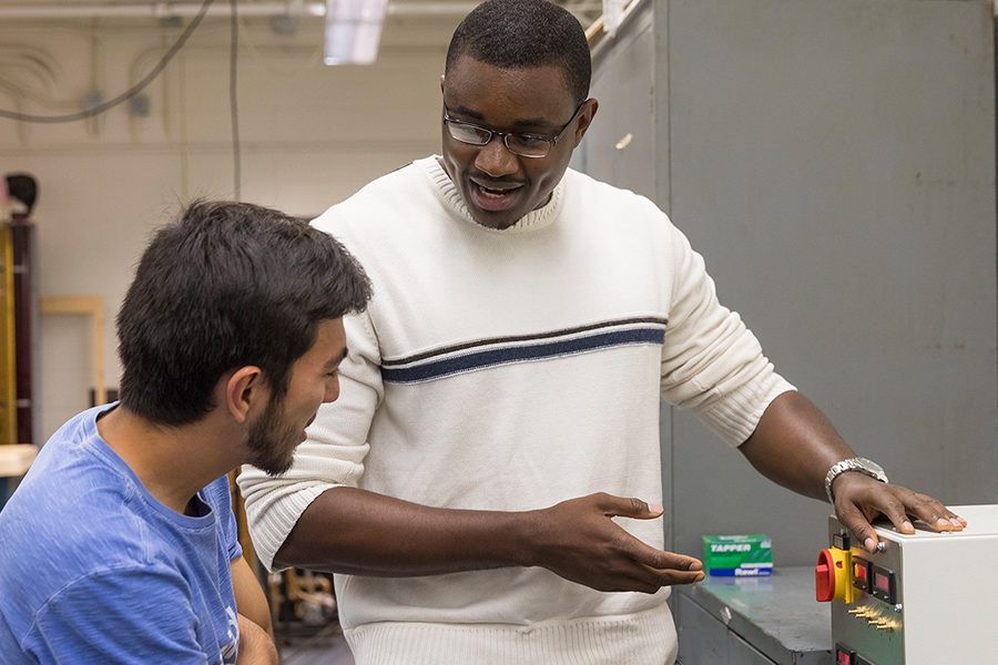 Professor showing a student a piece of equipment