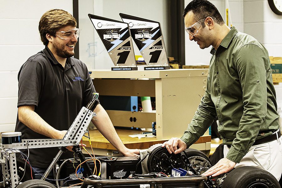 dr. khair al shamaileh working with engineering student on electric car