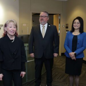 Geri Richmond, Chenn Zhou and Chris Holford stand in the CIVS lobby