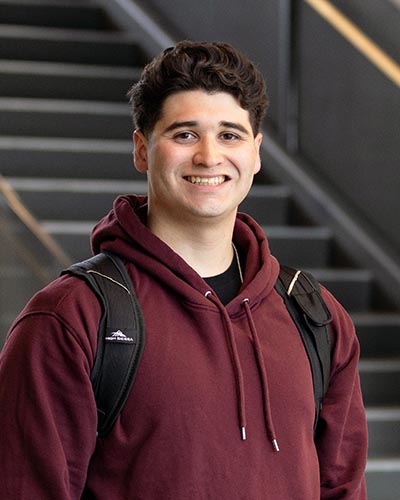 A PNW student stands indoors