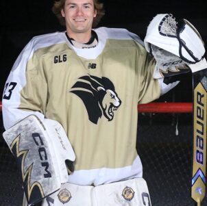 PNW Graduate Cooper Olson poses in hockey goalie gear