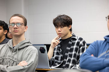 Engineering students sit in a lecture hall.