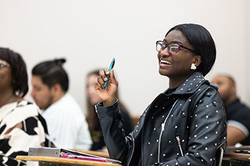 A PNW student laughs in the classroom