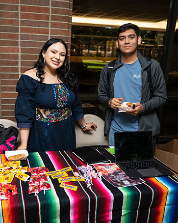 Students stand in front of an event booth