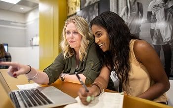 Students are looking at a laptop together.