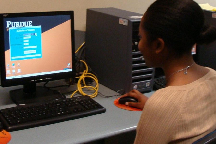 A student working on a computer is pictured.