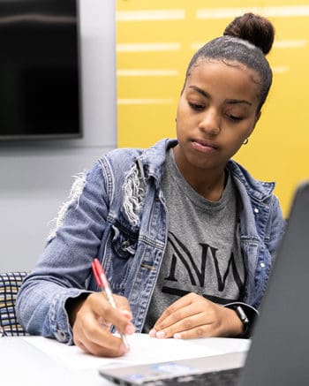 A PNW student works at a computer.