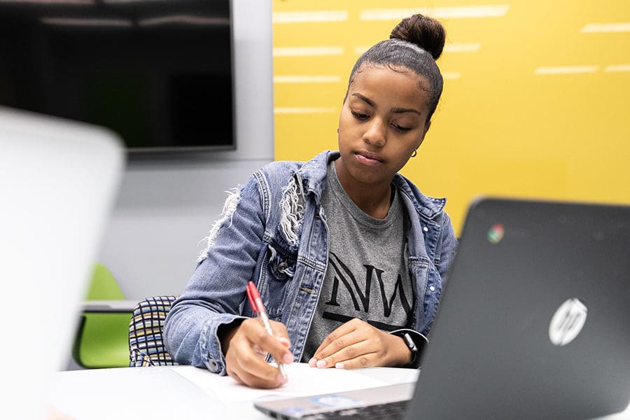 A PNW student works at a computer.