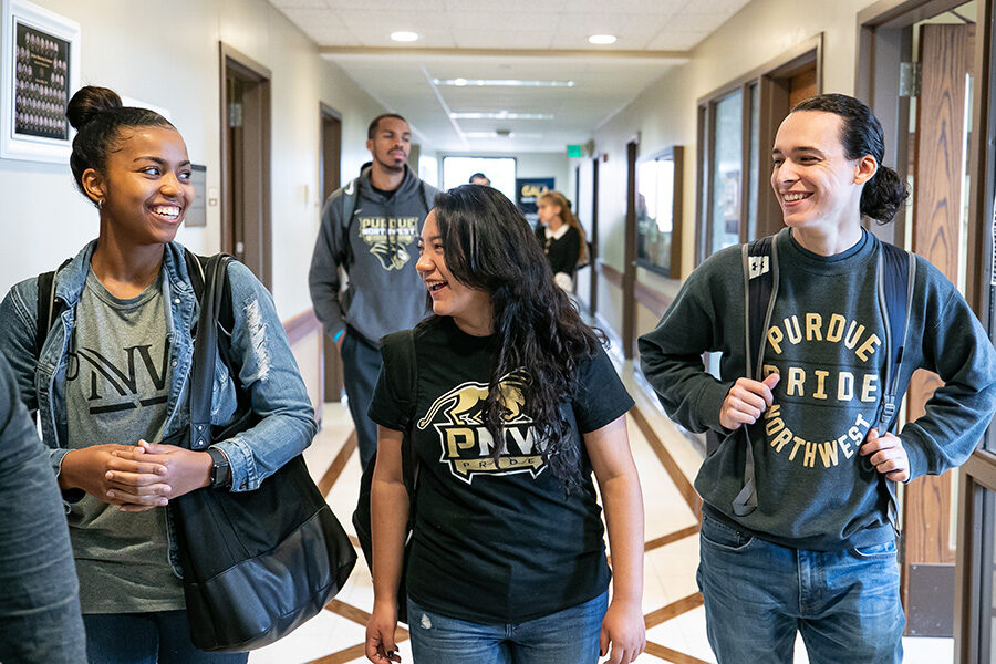 PNW students walk down a hallway
