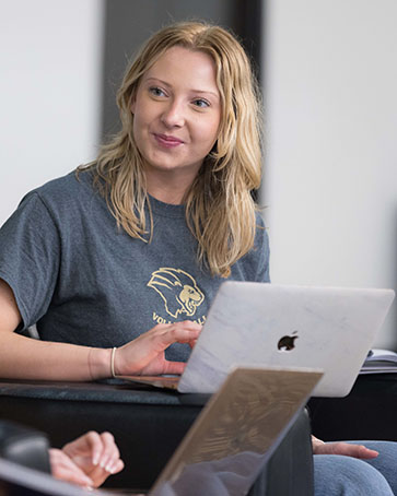 A PNW student with a laptop computer