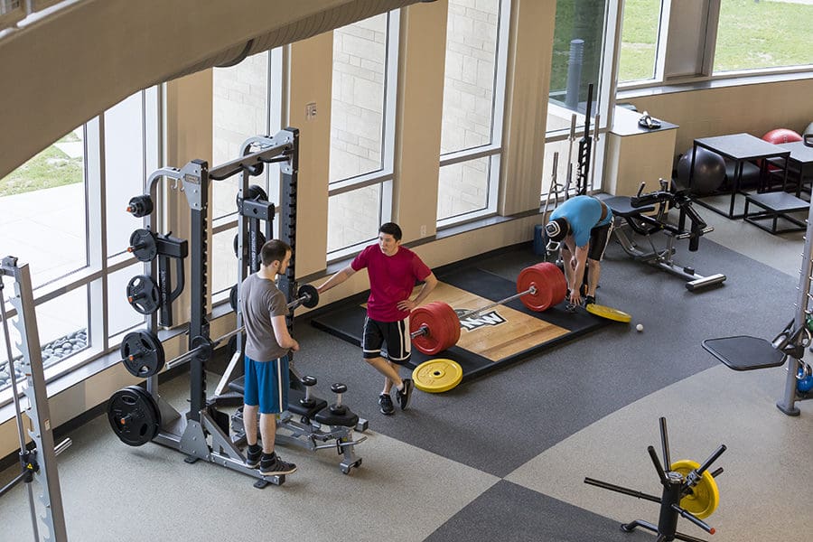 Students prepare to lift weights.