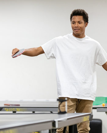 A student plays ping pong
