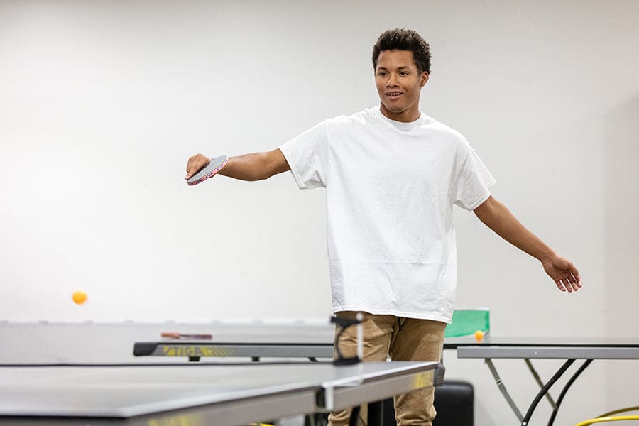 A student plays ping pong