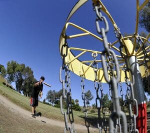 Image of people playing disc golf.