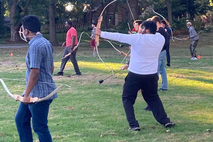 Many students with bows and arrows