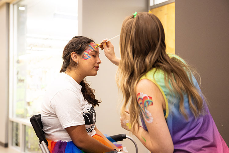 A student gets their face painted