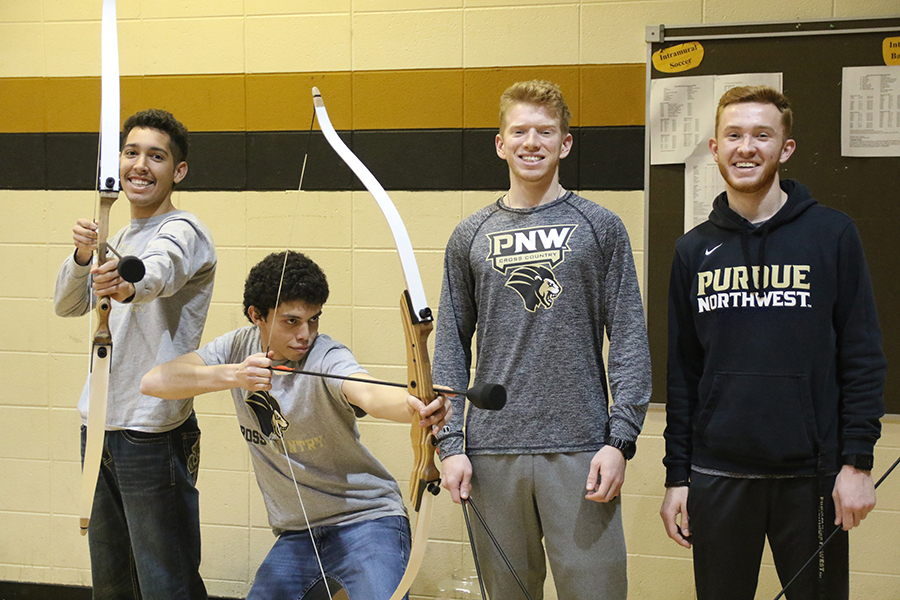Combat Archery Participants pose with bow and arrow