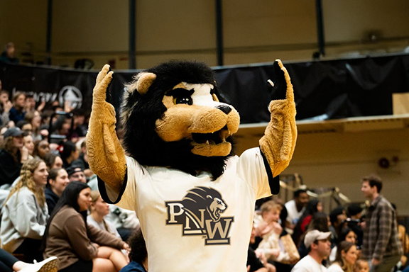 Leo the Lion mascot cheering in the crowd