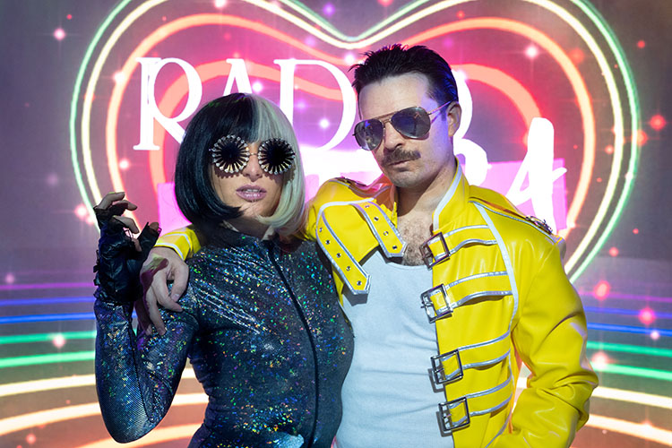 A promo photo of performers from Radio Gaga dressed up as Lady Gaga and Freddie Mercury.