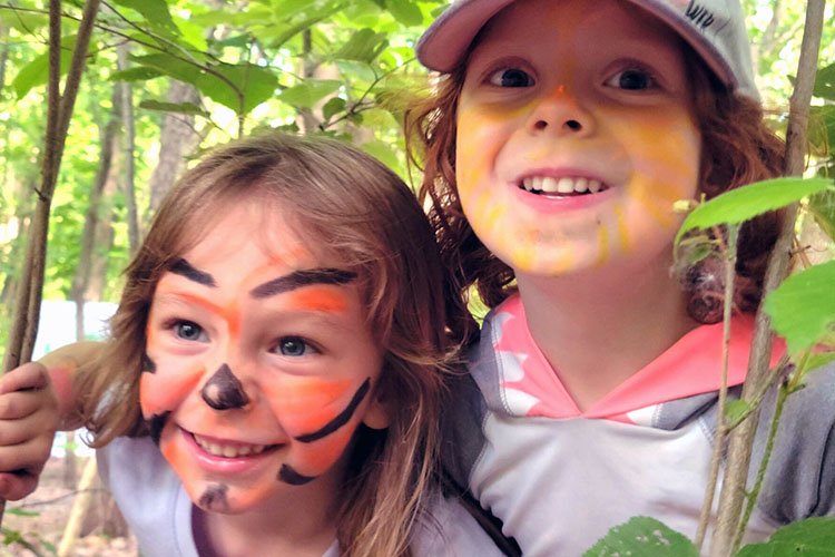 Kids in face paint play outdoors