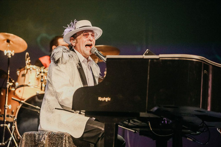 Elton Jeff playing the baby grand piano