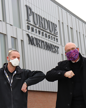 Jacob Lenson, assistant vice chancellor of campus planning, project and space management, and Chancellor Keon celebrate the handover of the Nils K. Nelson Bioscience Innovation Building.