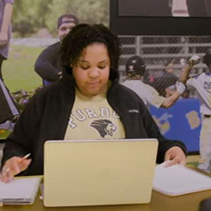 PNW student Tamar Clark works at a laptop.
